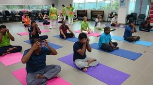 Participants doing facial massage for Navayugum Yoga session