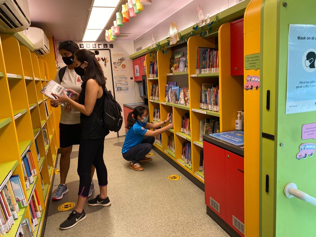 Patrons at MOLLY browsing books