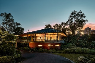 View of Pangium restaurant at Gallop Extension of the Singapore Botanic Gardens with the rising sun at the back