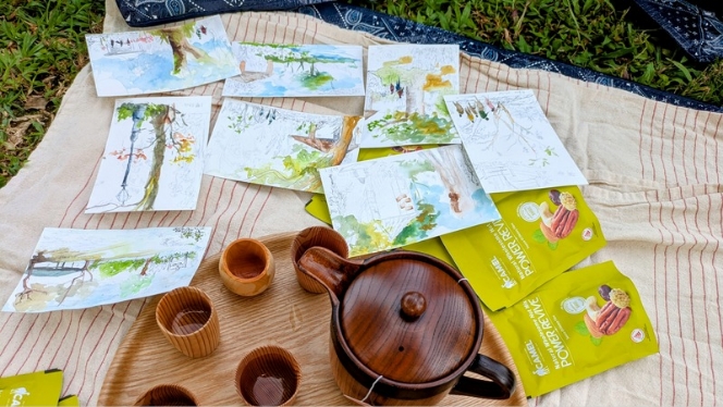 Nature art sketching and tea set on a picnic mat